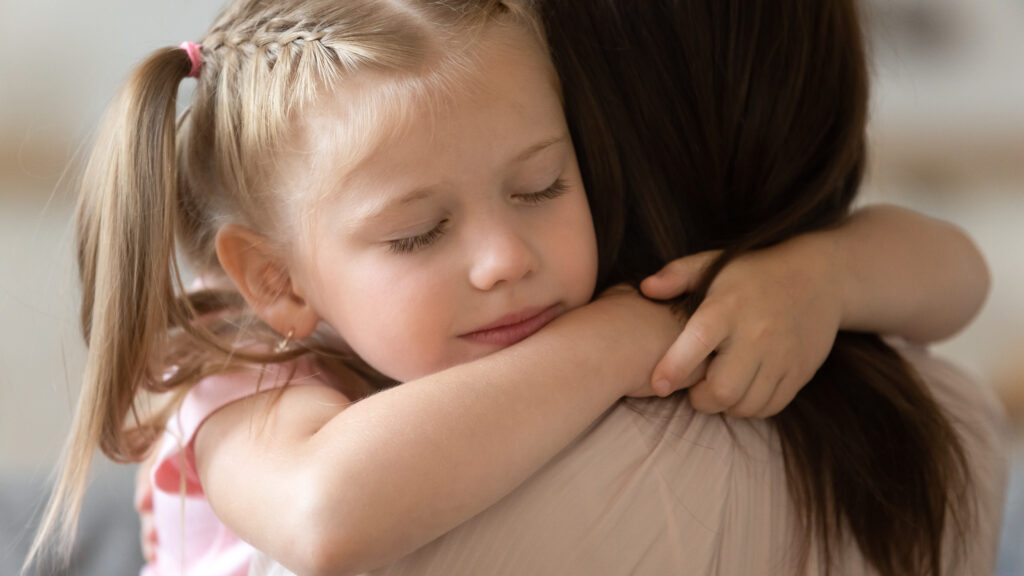 Child hugging their foster parent.