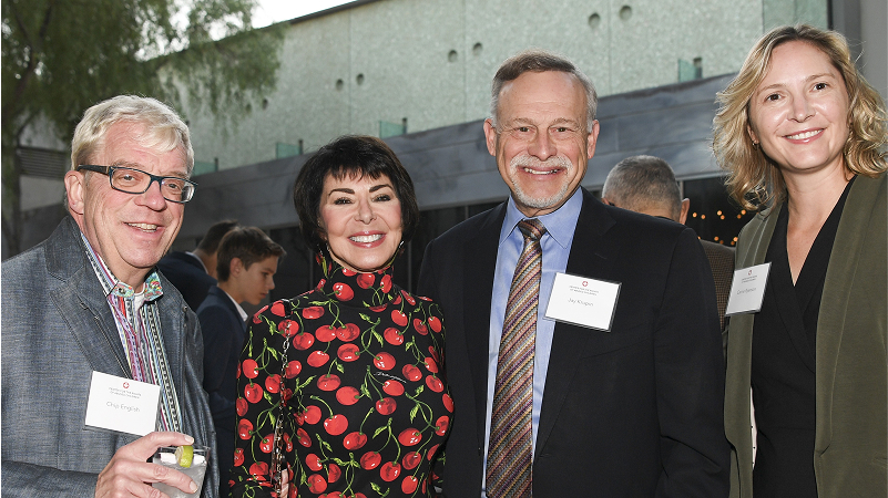 Group of four smiling individuals at a fundraising event for the Center for the Rights of Abused Children, showcasing community support and advocacy for child welfare.